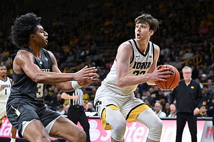 Nov 29, 2022; Iowa City, Iowa, USA; Iowa Hawkeyes forward Patrick McCaffery (22) is defended by Georgia Tech Yellow Jackets guard Dallan Coleman (3) during the second half at Carver-Hawkeye Arena. Mandatory Credit: Jeffrey Becker-USA TODAY Sports