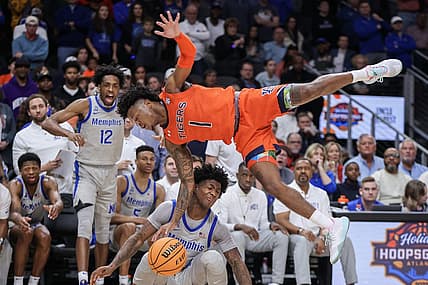 Dec 10, 2022; Atlanta, Georgia, USA; Auburn Tigers guard Wendell Green Jr. (1) dives over Memphis Tigers guard Kendric Davis (3) in the second half at State Farm Arena. Mandatory Credit: Brett Davis-USA TODAY Sports