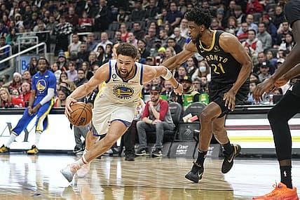 Dec 18, 2022; Toronto, Ontario, CAN;  Golden State Warriors guard Klay Thompson (11) drives to the net against Toronto Raptors forward Thaddeus Young (21) during the first half at Scotiabank Arena. Mandatory Credit: John E. Sokolowski-USA TODAY Sports