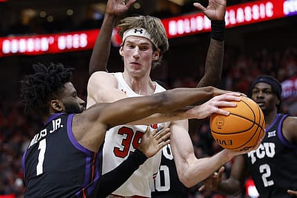 Dec 21, 2022; Salt Lake City, Utah, USA; TCU Horned Frogs guard Mike Miles Jr. (1) and Utah Utes center Branden Carlson (35) battle in the second half at Vivint Arena. Mandatory Credit: Jeffrey Swinger-USA TODAY Sports