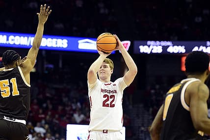 Dec 30, 2022; Madison, Wisconsin, USA; Wisconsin Badgers forward Steven Crowl (22) shoots a three-pointer against Western Michigan Broncos guard Jefferson Monegro (5) during the second half at the Kohl Center. Mandatory Credit: Kayla Wolf-USA TODAY Sports