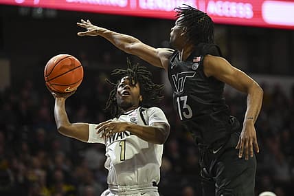 Dec 31, 2022; Winston-Salem, North Carolina, USA; Wake Forest Demon Deacons guard Tyree Appleby (1) shoots over Virginia Tech Hokies guard Darius Maddox (13) during the first half at Lawrence Joel Veterans Memorial Coliseum. Mandatory Credit: William Howard-USA TODAY Sports