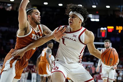 Oklahoma Sooners forward Jalen Hill (1) tries top get past Texas Longhorns forward Timmy Allen (0) during an NCAA men's college basketball game between the University of Oklahoma and Texas at Lloyd Noble Center in Norman, Okla., Saturday, Dec. 31, 2022. Texas won 70-69.

Oklahoma Vs Texas Basketball