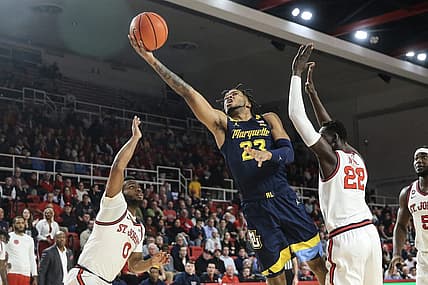 Jan 3, 2023; Queens, New York, USA; Marquette Golden Eagles forward David Joplin (23) drives past St. John's Red Storm forward Esahia Nyiwe (22) for a layup in the first half at Carnesecca Arena. Mandatory Credit: Wendell Cruz-USA TODAY Sports