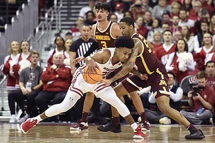Jan 3, 2023; Madison, Wisconsin, USA; Wisconsin Badgers guard Chucky Hepburn (23) dribbles the ball under coverage by Minnesota Golden Gophers guard Ta'lon Cooper (55) during the first half at the Kohl Center. Mandatory Credit: Kayla Wolf-USA TODAY Sports
