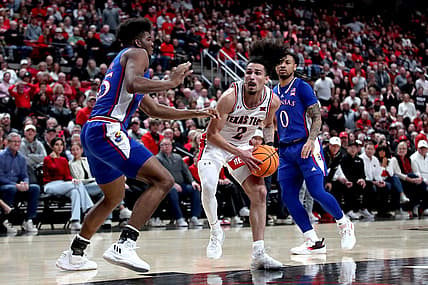 Jan 3, 2023; Lubbock, Texas, USA;  Texas Tech Red Raiders guard Pop Isaacs (2) drives to the lane against Kansas Jayhawks forward Zuby Ejiofor (35) in the first half at United Supermarkets Arena. Mandatory Credit: Michael C. Johnson-USA TODAY Sports