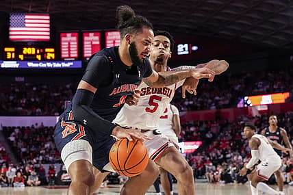 Jan 4, 2023; Athens, Georgia, USA; Auburn Tigers forward Johni Broome (4) dribbles against Georgia Bulldogs center Frank Anselem (5) during the first half at Stegeman Coliseum. Mandatory Credit: Dale Zanine-USA TODAY Sports