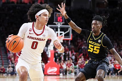 Jan 4, 2023; Fayetteville, Arkansas, USA; Arkansas Razorbacks guard Anthony Black (0) drives in the first half as Missouri Tigers guard Sean East II (55) defends at Bud Walton Arena. Mandatory Credit: Nelson Chenault-USA TODAY Sports