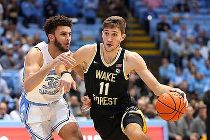 Jan 4, 2023; Chapel Hill, North Carolina, USA;  Wake Forest Demon Deacons forward Andrew Carr (11) dribbles as North Carolina Tar Heels forward Pete Nance (32) defends in the first half at Dean E. Smith Center. Mandatory Credit: Bob Donnan-USA TODAY Sports