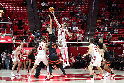 Jan 5, 2023; Salt Lake City, Utah, USA; Oregon State Beavers forward Dzmitry Ryuny (11) and Utah Utes center Branden Carlson (35) jump to tip of their game at Jon M. Huntsman Center. Mandatory Credit: Rob Gray-USA TODAY Sports