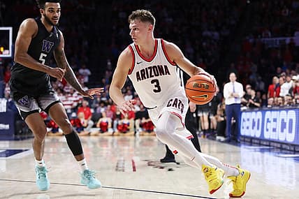 Jan 5, 2023; Tucson, Arizona, USA; Arizona Wildcats guard Pelle Larsson (3) drives to the net against Washington Huskies guard Jamal Bey (5) during the second half at McKale Center. Mandatory Credit: Zachary BonDurant-USA TODAY Sports
