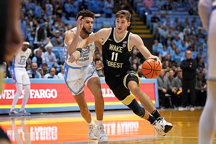 Jan 4, 2023; Chapel Hill, North Carolina, USA; Wake Forest Demon Deacons forward Andrew Carr (11) with the ball as North Carolina Tar Heels forward Pete Nance (32) defends in the first half at Dean E. Smith Center. Mandatory Credit: Bob Donnan-USA TODAY Sports