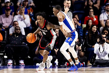 Jan 7, 2023; Gainesville, Florida, USA; Georgia Bulldogs guard Terry Roberts (0) dribbles the ball around Florida Gators guard Kyle Lofton (11) during the second half at Exactech Arena at the Stephen C. O'Connell Center. Mandatory Credit: Matt Pendleton-USA TODAY Sports