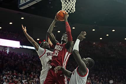 Jan 7, 2023; Tucson, Arizona, USA; Washington State Cougars forward Mouhamed Gueye (35) goes up for a layup against Arizona Wildcats guard Courtney Ramey (0) and Arizona Wildcats center Oumar Ballo (11) during the first half at McKale Center. Mandatory Credit: Joe Camporeale-USA TODAY Sports