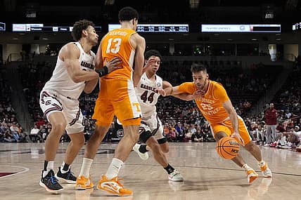 Jan 7, 2023; Columbia, South Carolina, USA; Tennessee Volunteers guard Santiago Vescovi (25) drives around a pic set by forward Olivier Nkamhoua (13) away from South Carolina Gamecocks guard Ford Cooper Jr. (44) during the second half at Colonial Life Arena. Mandatory Credit: Jim Dedmon-USA TODAY Sports