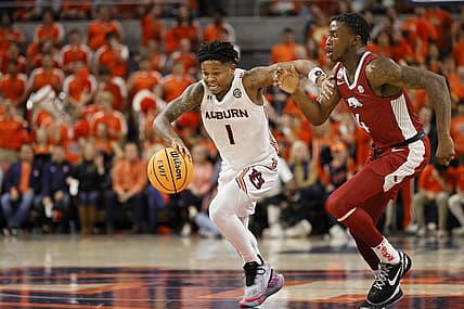 Jan 7, 2023; Auburn, Alabama, USA;  Auburn Tigers guard Wendell Green Jr. (1) moves the ball against Arkansas Razorbacks guard Davonte Davis (4) during the second half at Neville Arena. Mandatory Credit: John Reed-USA TODAY Sports