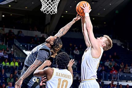 Jan 10, 2023; South Bend, Indiana, USA; Georgia Tech Yellow Jackets guard Deivon Smith (5) and Notre Dame Fighting Irish guard Dane Goodwin (23) reach for a rebound in the first half at the Purcell Pavilion. Mandatory Credit: Matt Cashore-USA TODAY Sports