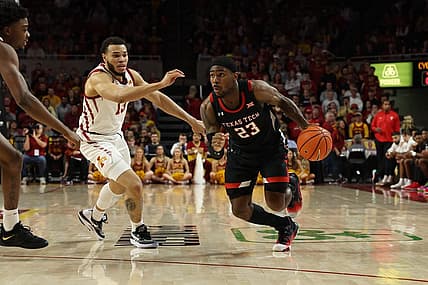 Jan 10, 2023; Ames, Iowa, USA; Texas Tech Red Raiders guard De'Vion Harmon (23) drives past Iowa State Cyclones guard Jaren Holmes (13) at James H. Hilton Coliseum. Mandatory Credit: Reese Strickland-USA TODAY Sports