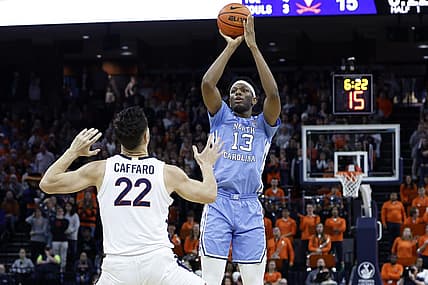 Jan 10, 2023; Charlottesville, Virginia, USA; North Carolina Tar Heels forward Jalen Washington (13) shoots the ball over Virginia Cavaliers center Francisco Caffaro (22) in the first half at John Paul Jones Arena. Mandatory Credit: Geoff Burke-USA TODAY Sports