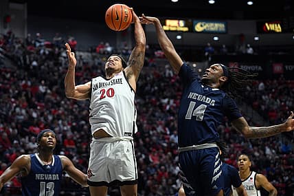 Jan 10, 2023; San Diego, California, USA; San Diego State Aztecs guard Matt Bradley (20) goes to the basket while defended by Nevada Wolf Pack forward Tre Coleman (14) during the second half at Viejas Arena. Mandatory Credit: Orlando Ramirez-USA TODAY Sports