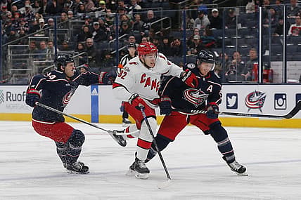 Jan 12, 2023; Columbus, Ohio, USA; Carolina Hurricanes center Jesperi Kotkaniemi (82) avoids then check from Columbus Blue Jackets center Gustav Nyquist (14) during the first period at Nationwide Arena. Mandatory Credit: Russell LaBounty-USA TODAY Sports