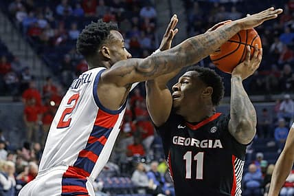 Jan 14, 2023; Oxford, Mississippi, USA; Georgia Bulldogs guard Justin Hill (11) drives to the basket against Mississippi Rebels guard TJ Caldwell (2) during the first half at The Sandy and John Black Pavilion at Ole Miss. Mandatory Credit: Petre Thomas-USA TODAY Sports