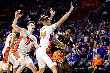 Jan 14, 2023; Gainesville, Florida, USA; Missouri Tigers guard Kobe Brown (24) passes around Florida Gators guard Riley Kugel (24) during the first half at Exactech Arena at the Stephen C. O'Connell Center. Mandatory Credit: Matt Pendleton-USA TODAY Sports