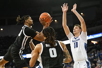 Jan 14, 2023; Omaha, Nebraska, USA;  Providence Friars forward Bryce Hopkins (23) attempts an off balanced shot against Creighton Bluejays center Ryan Kalkbrenner (11) in the second half at CHI Health Center Omaha. Mandatory Credit: Steven Branscombe-USA TODAY Sports