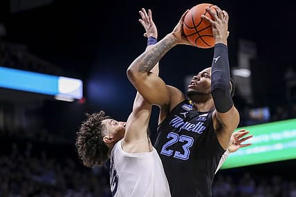 Jan 15, 2023; Cincinnati, Ohio, USA; Marquette Golden Eagles forward David Joplin (23) shoots against Xavier Musketeers guard Colby Jones (3) in the first half at Cintas Center. Mandatory Credit: Katie Stratman-USA TODAY Sports