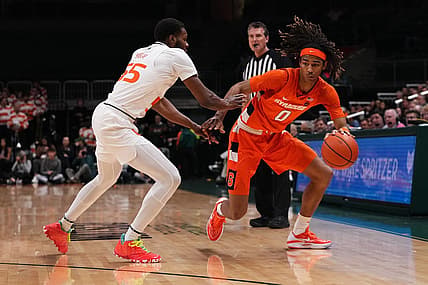 Jan 16, 2023; Coral Gables, Florida, USA; Syracuse Orange forward Chris Bell (0) dribbles the ball around Miami Hurricanes guard Wooga Poplar (55) during the first half at Watsco Center. Mandatory Credit: Jasen Vinlove-USA TODAY Sports