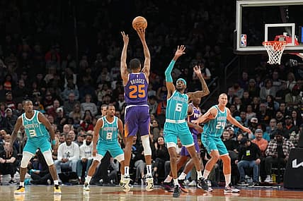 Jan 24, 2023; Phoenix, Arizona, USA; Phoenix Suns forward Mikal Bridges (25) shoots over Charlotte Hornets forward Jalen McDaniels (6) during the first half at Footprint Center. Mandatory Credit: Joe Camporeale-USA TODAY Sports