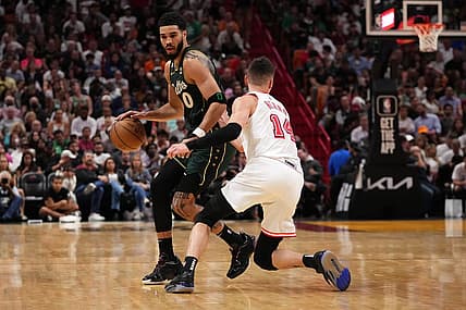 Jan 24, 2023; Miami, Florida, USA; Boston Celtics forward Jayson Tatum (0) dribbles the ball around Miami Heat guard Tyler Herro (14) during the second half at Miami-Dade Arena. Mandatory Credit: Jasen Vinlove-USA TODAY Sports