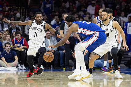 Jan 25, 2023; Philadelphia, Pennsylvania, USA; Philadelphia 76ers center Joel Embiid (21) controls a loose ball over Brooklyn Nets guard Kyrie Irving (11) and guard Ben Simmons (10) during the second quarter at Wells Fargo Center. Mandatory Credit: Bill Streicher-USA TODAY Sports