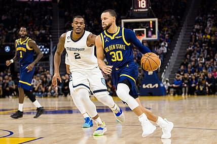 Jan 25, 2023; San Francisco, California, USA; Golden State Warriors guard Stephen Curry (30) dribbles past Memphis Grizzlies center Xavier Tillman Sr. (2) during the first half at Chase Center. Mandatory Credit: John Hefti-USA TODAY Sports