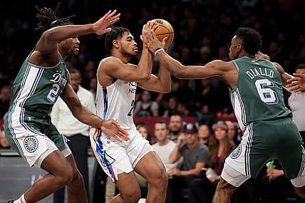 Jan 26, 2023; Brooklyn, New York, USA; Brooklyn Nets guard Cam Thomas (24) looks to pass the ball against Detroit Pistons center Isaiah Stewart (28) and guard Hamidou Diallo (6) during the first quarter at Barclays Center. Mandatory Credit: Brad Penner-USA TODAY Sports