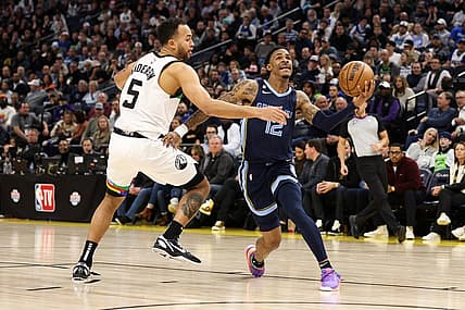 Jan 27, 2023; Minneapolis, Minnesota, USA; Memphis Grizzlies guard Ja Morant (12) drives to the basket while Minnesota Timberwolves forward Kyle Anderson (5) defends during the fourth quarter at Target Center. Mandatory Credit: Matt Krohn-USA TODAY Sports