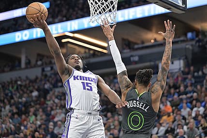 Jan 28, 2023; Minneapolis, Minnesota, USA; Sacramento Kings guard Davion Mitchell (15) goes to the basket as Minnesota Timberwolves guard D'Angelo Russell (0) defends during the second quarter at Target Center. Mandatory Credit: Jeffrey Becker-USA TODAY Sports