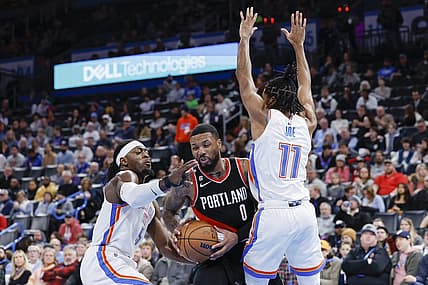 Dec 21, 2022; Oklahoma City, Oklahoma, USA;  Portland Trail Blazers guard Damian Lillard (0) is defended by Oklahoma City Thunder guard Luguentz Dort (5) and guard Isaiah Joe (11) during the second quarter at Paycom Center. Mandatory Credit: Alonzo Adams-USA TODAY Sports