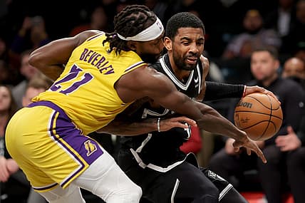 Jan 30, 2023; Brooklyn, New York, USA; Brooklyn Nets guard Kyrie Irving (11) is fouled as he brings the ball up court by Los Angeles Lakers guard Patrick Beverley (21) during the second quarter at Barclays Center. Mandatory Credit: Brad Penner-USA TODAY Sports