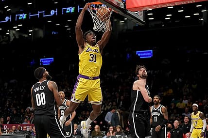 Jan 30, 2023; Brooklyn, New York, USA; Los Angeles Lakers center Thomas Bryant (31) dunks against Brooklyn Nets forwards Royce O'Neale (00) and Joe Harris (12) during the third quarter at Barclays Center. Mandatory Credit: Brad Penner-USA TODAY Sports