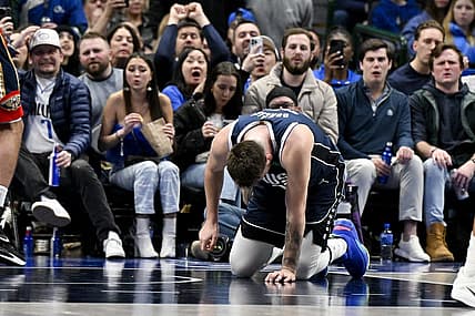 Feb 2, 2023; Dallas, Texas, USA; Dallas Mavericks guard Luka Doncic (77) kneels on the floor after he is fouled by New Orleans Pelicans forward Brandon Ingram (not pictured) as he drives to the basket during the second half at the American Airlines Center. Mandatory Credit: Jerome Miron-USA TODAY Sports