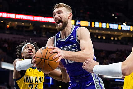Feb 3, 2023; Indianapolis, Indiana, USA; Sacramento Kings forward Domantas Sabonis (10) rebounds the ball while  Indiana Pacers guard Buddy Hield (24) defends in the second half at Gainbridge Fieldhouse. Mandatory Credit: Trevor Ruszkowski-USA TODAY Sports
