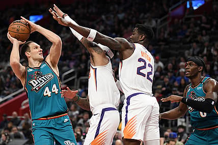 Feb 4, 2023; Detroit, Michigan, USA;  Detroit Pistons forward Bojan Bogdanovic (44) controls the ball against Phoenix Suns forward Torey Craig (middle) and center Deandre Ayton (22) in the first quarter at Little Caesars Arena. Mandatory Credit: Lon Horwedel-USA TODAY Sports