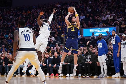 Feb 4, 2023; San Francisco, California, USA; Golden State Warriors guard Klay Thompson (11) shoots the ball over Dallas Mavericks forward Tim Hardaway Jr. (11) in the fourth quarter at the Chase Center. Mandatory Credit: Cary Edmondson-USA TODAY Sports