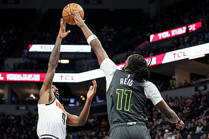 Feb 5, 2023; Minneapolis, Minnesota, USA; Denver Nuggets guard Davon Reed (9) is blocked by Minnesota Timberwolves center Naz Reid (11) during the second quarter at Target Center. Mandatory Credit: Brace Hemmelgarn-USA TODAY Sports