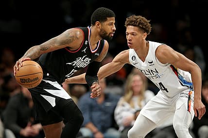Feb 6, 2023; Brooklyn, New York, USA; Los Angeles Clippers guard Paul George (13) controls the ball against Brooklyn Nets forward Kessler Edwards (14) during the second quarter at Barclays Center. Mandatory Credit: Brad Penner-USA TODAY Sports
