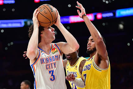 Feb 7, 2023; Los Angeles, California, USA; Oklahoma City Thunder guard Josh Giddey (3) shoots against Los Angeles Lakers forward Troy Brown Jr. (7) in the first half at Crypto.com Arena. Mandatory Credit: Gary A. Vasquez-USA TODAY Sports