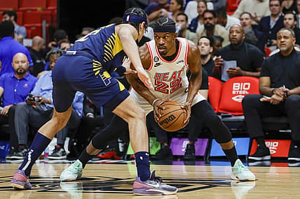 Feb 8, 2023; Miami, Florida, USA; Miami Heat forward Jimmy Butler (22) protects the ball from Indiana Pacers guard Andrew Nembhard (2) during the first quarter at Miami-Dade Arena. Mandatory Credit: Sam Navarro-USA TODAY Sports