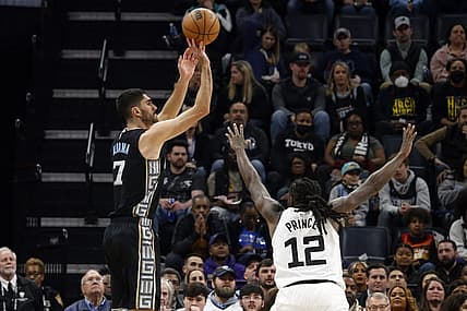 Feb 10, 2023; Memphis, Tennessee, USA; Memphis Grizzlies forward Santi Aldama (7) shoots for three as Minnesota Timberwolves forward Taurean Prince (12) defends during the first half at FedExForum. Mandatory Credit: Petre Thomas-USA TODAY Sports