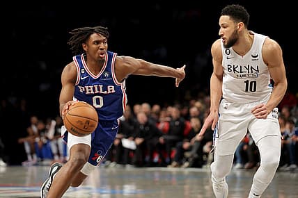 Feb 11, 2023; Brooklyn, New York, USA; Philadelphia 76ers guard Tyrese Maxey (0) drives to the basket against Brooklyn Nets guard Ben Simmons (10) during the second quarter at Barclays Center. Mandatory Credit: Brad Penner-USA TODAY Sports